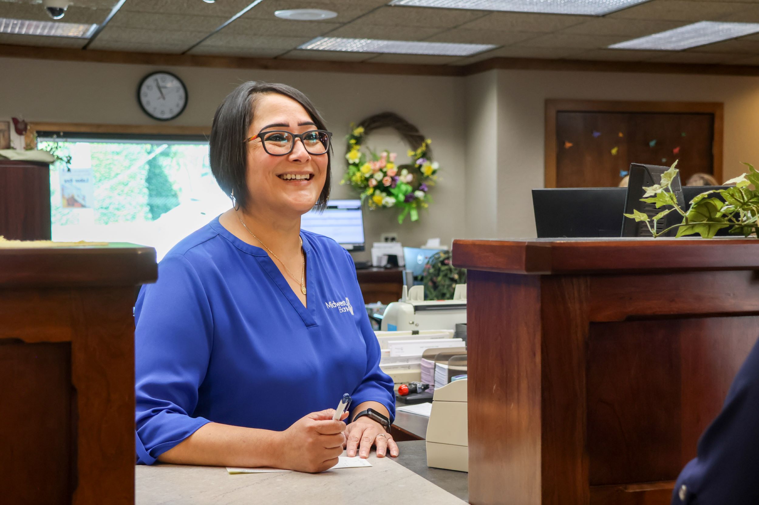 Dora, working at our front teller line helping a customer